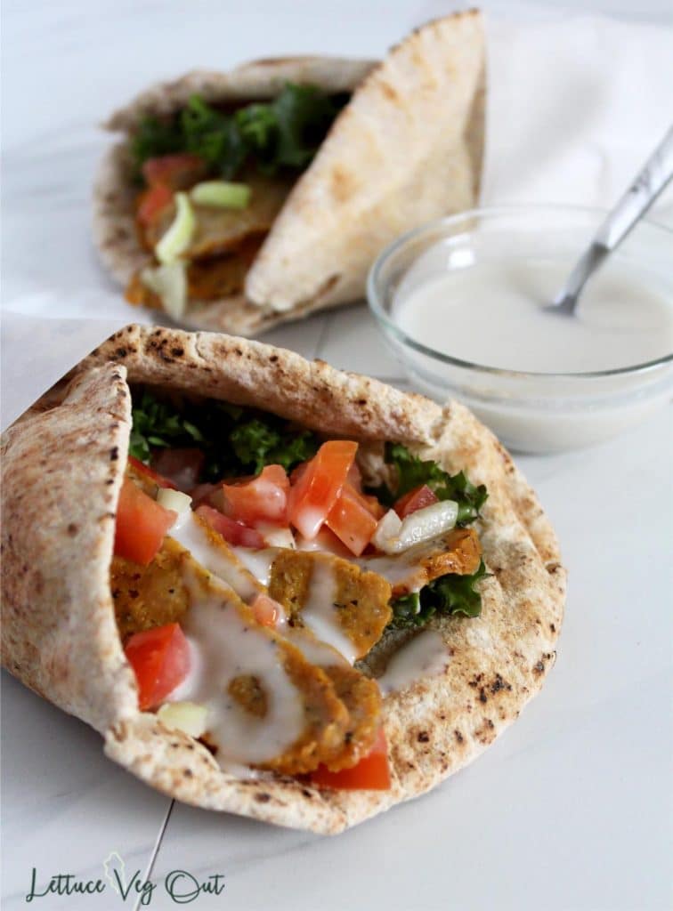 Two vegan donair wraps with donair sweet sauce in small glass bowl