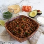 TVP tacos meat recipe in wooden bowl with taco filling options in background