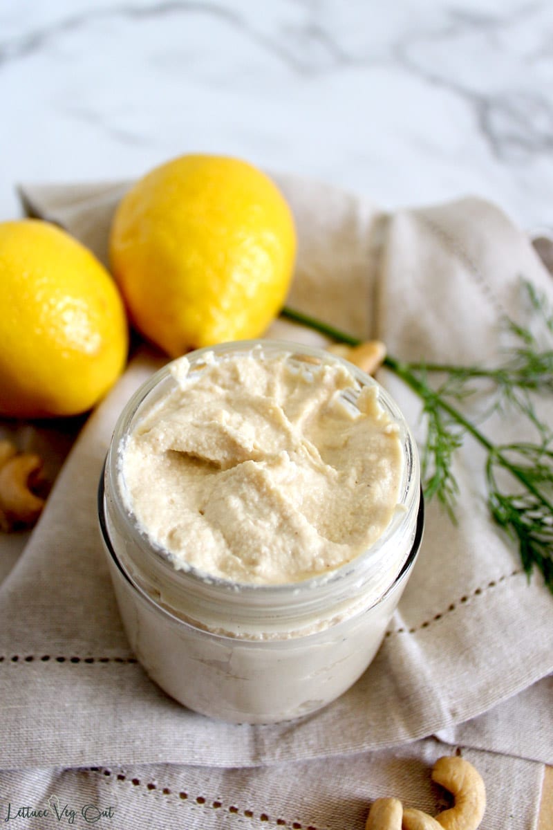 Overhead image of a jar full of cashew tofu sour cream made from vegan ingredients like lemon juice and nutritional yeast
