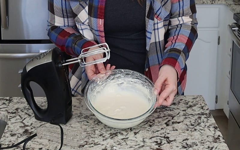 Fully mixed dairy free cream cheese frosting in a glass mixing bowl