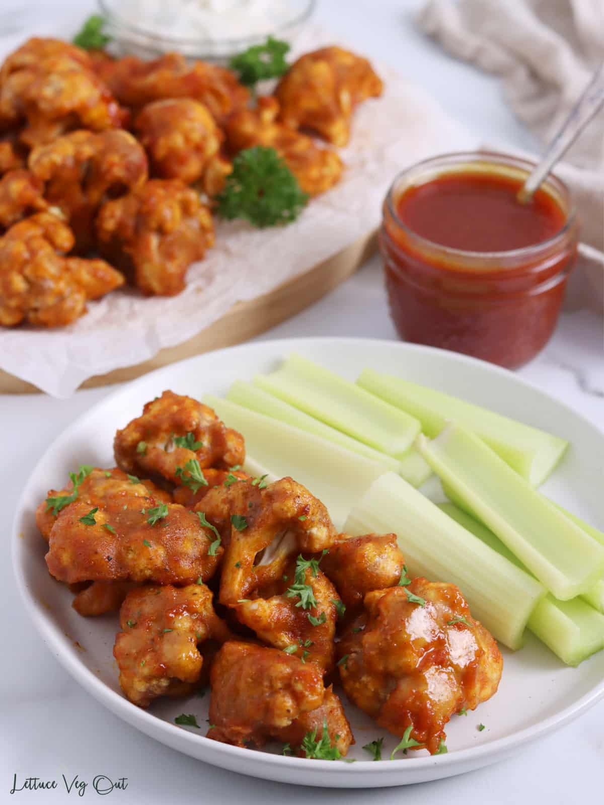 Plate with cauliflower wings and celery sticks.