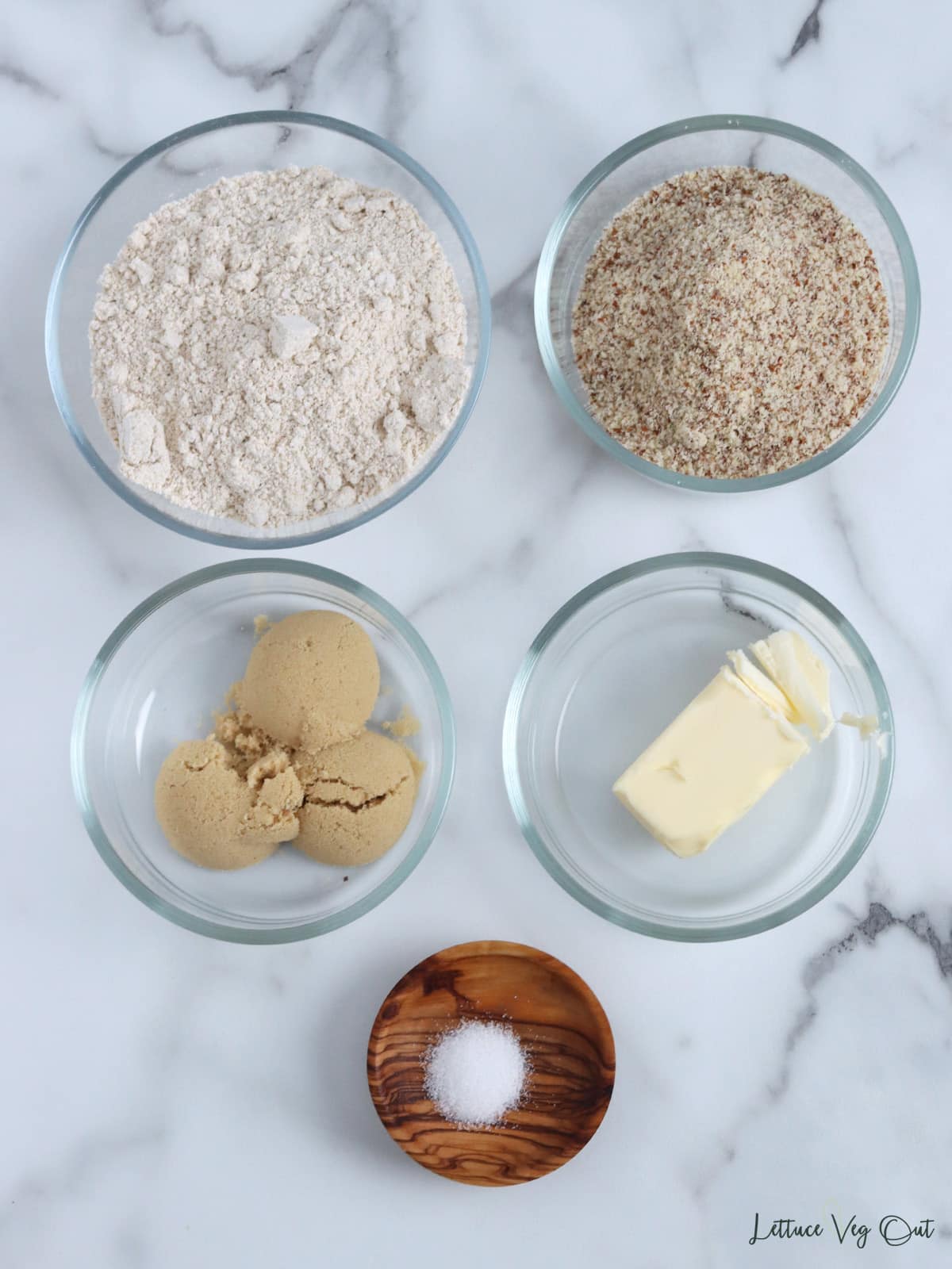 Small dishes with ingredients to make gluten free cheesecake crust.