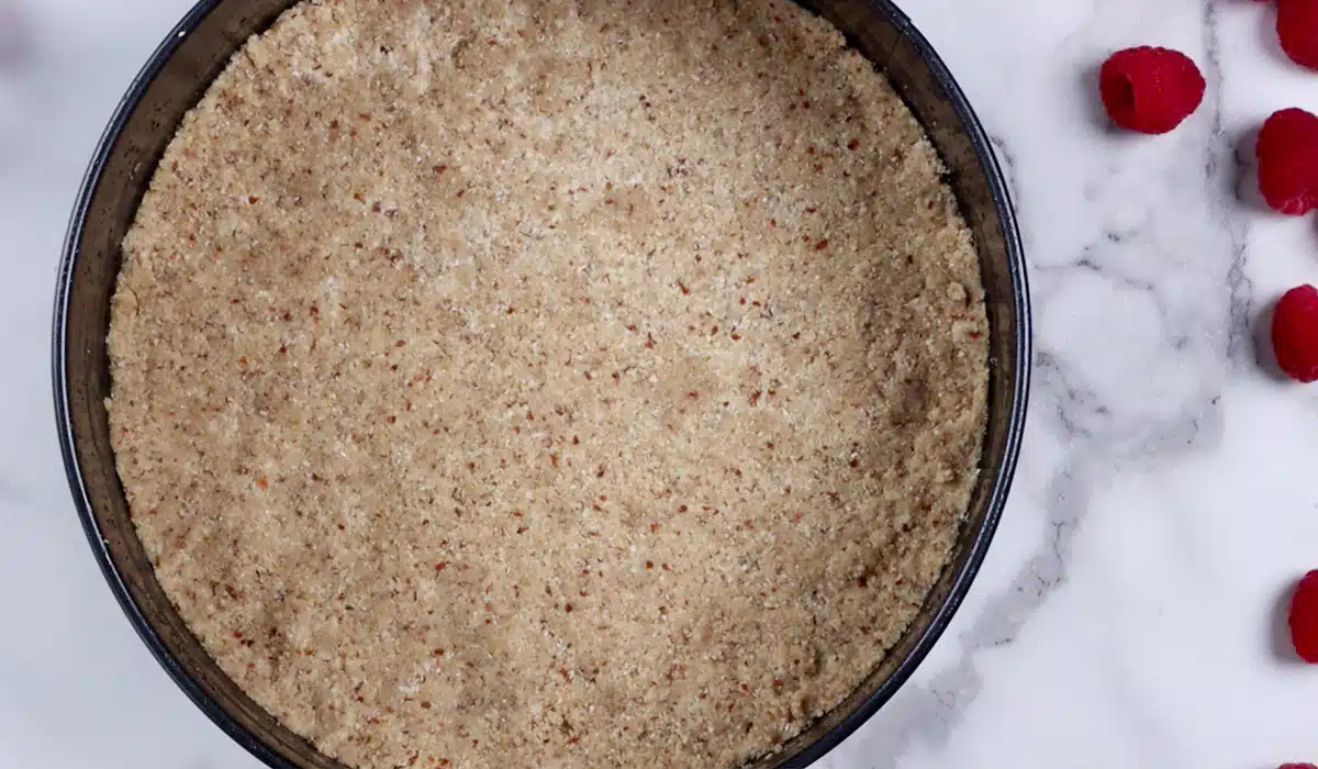 Cheesecake crust pressed into bottom of spring form pan.