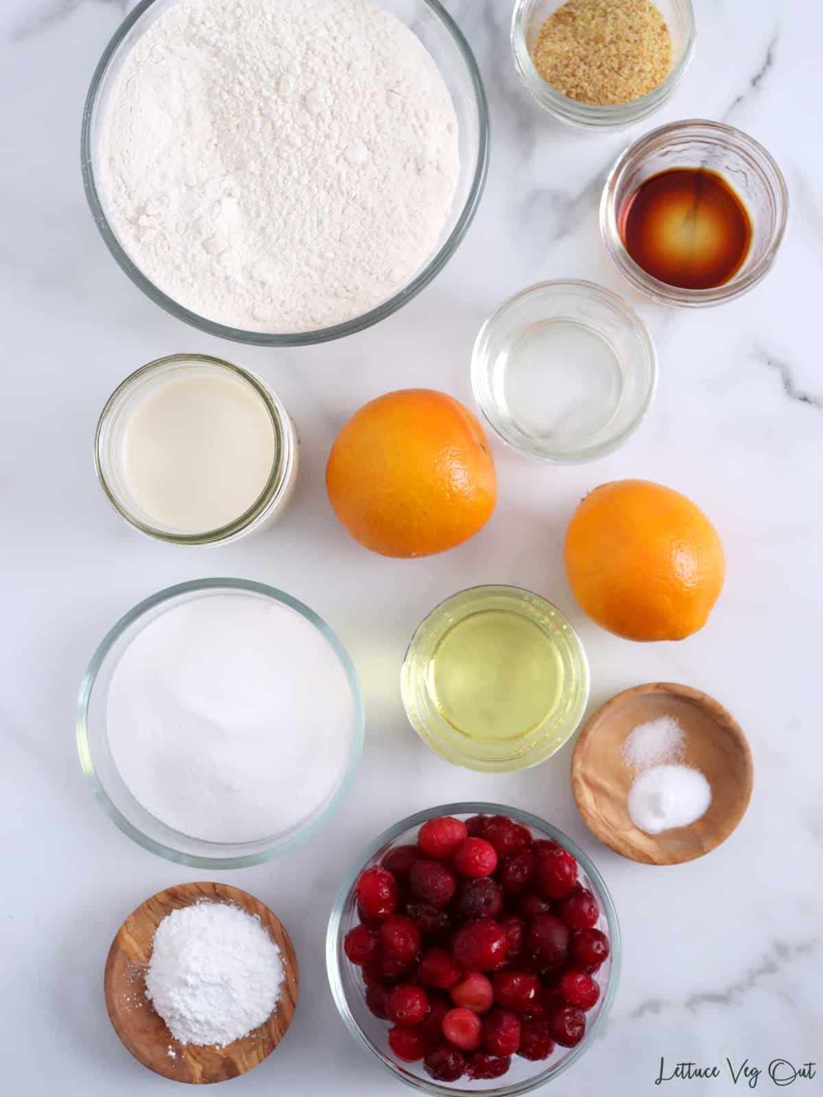 Small bowls with ingredients for cranberry orange muffins.